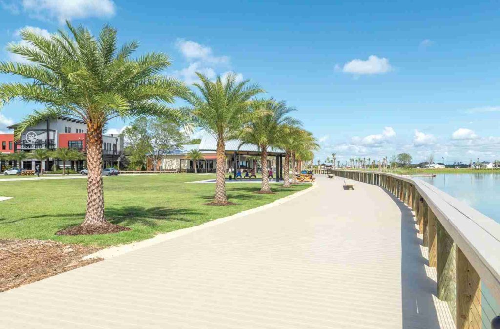 Palm-lined lakefront boardwalk beside the town centre at Babcock Ranch, Florida