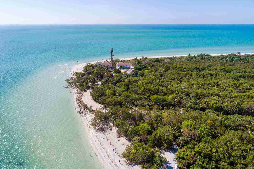 Aerial view of Sanibel Island's lighthouse, white sand beach and gulf shoreline