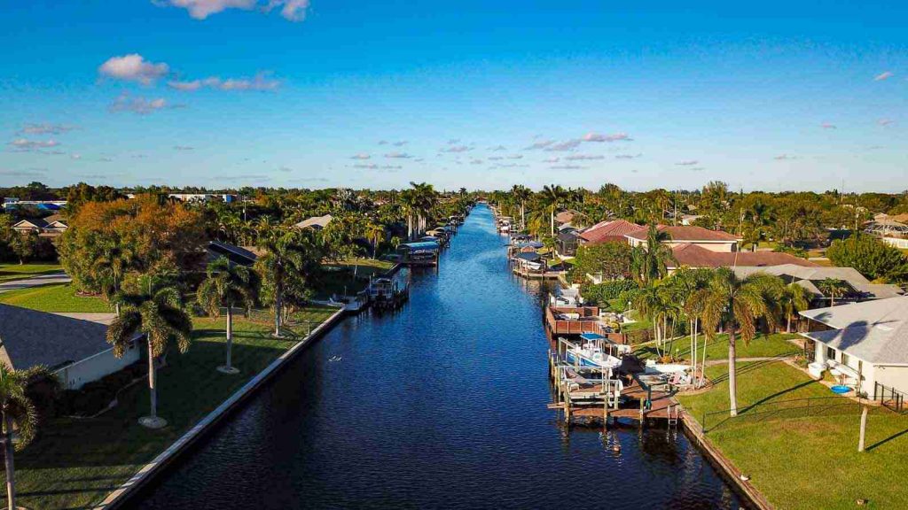 Aerial view of a Cape Coral canal lined with waterfront homes, docks and boat lifts