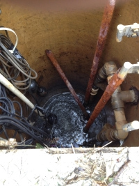 A sewage lift station before repair, with heavily corroded discharge piping